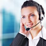 Woman wearing headset in office of debt collection agency
